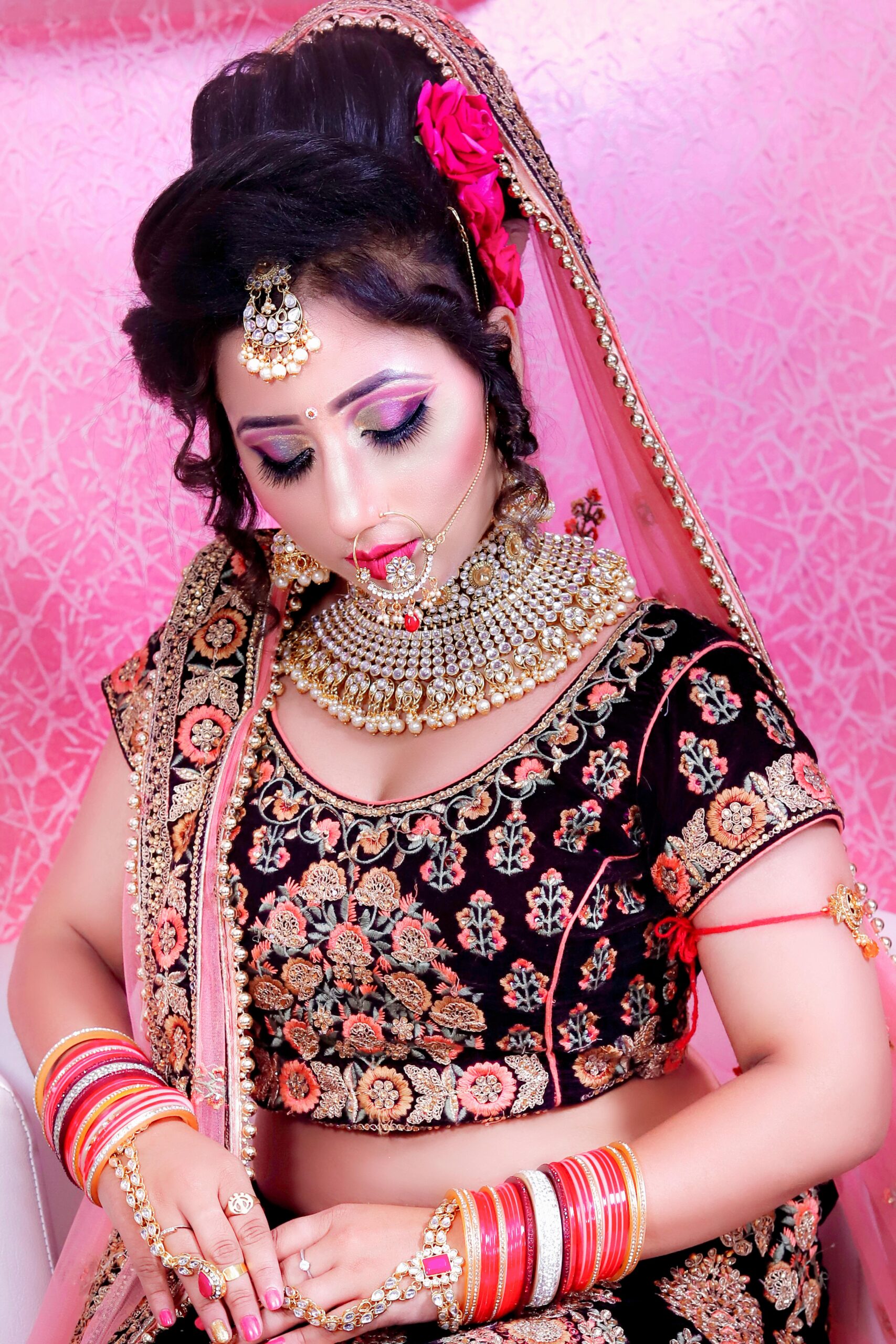 Stunning Indian bride adorned in traditional attire with exquisite jewelry and makeup.